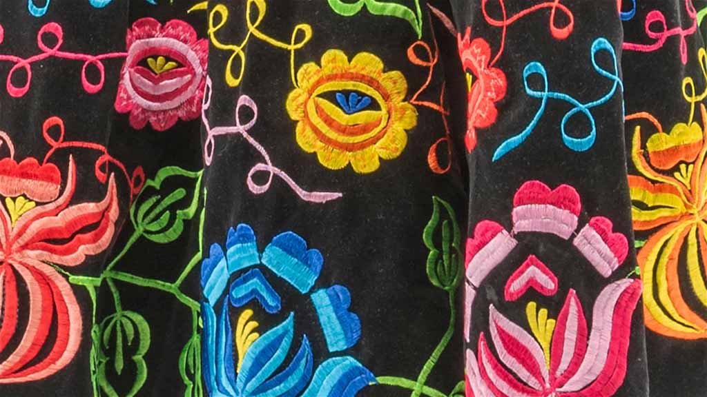 Close-up of colorful flower patterns on the black tehuana skirt