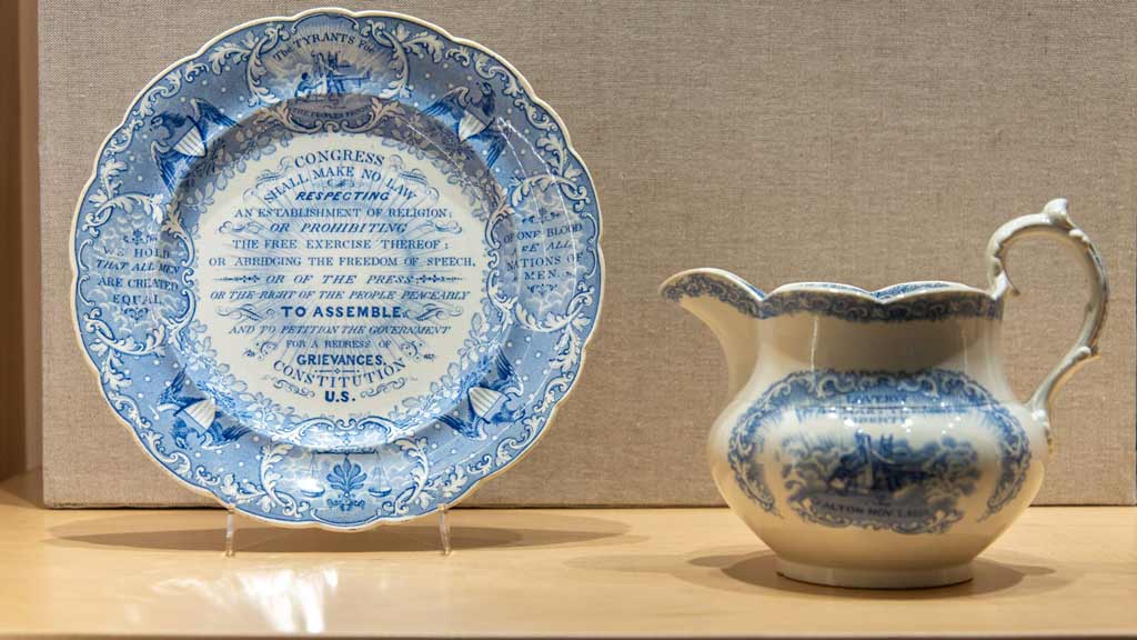 blue and white china plate with a decorative motif listing the first amendment to the US Constitution