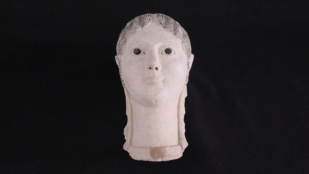 white plaster mask of a female face