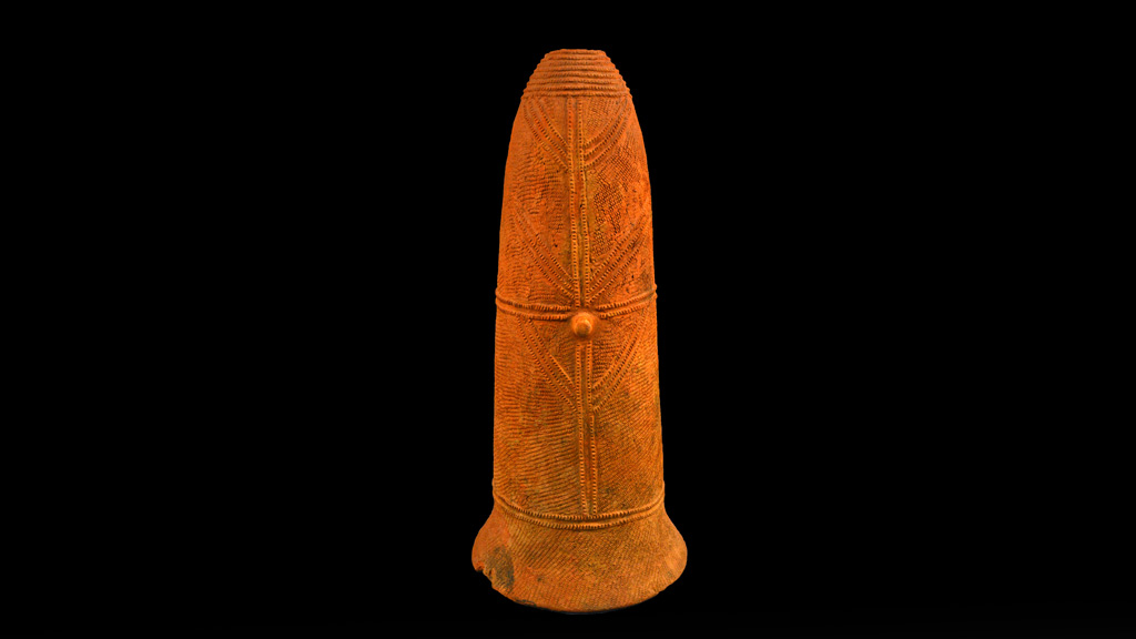 bright orange urn with many etched lines