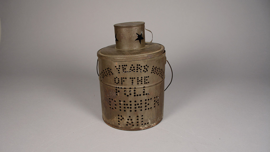 A rusty campaign torch with the words 'Four Years More of the Full Dinner Pail'