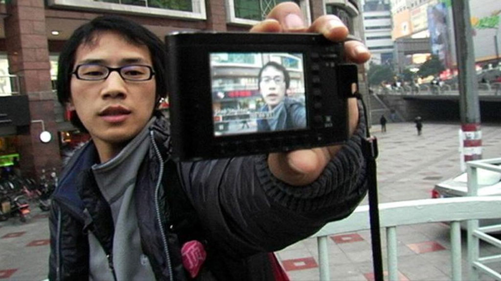 Still from film: Chinese man with video camera