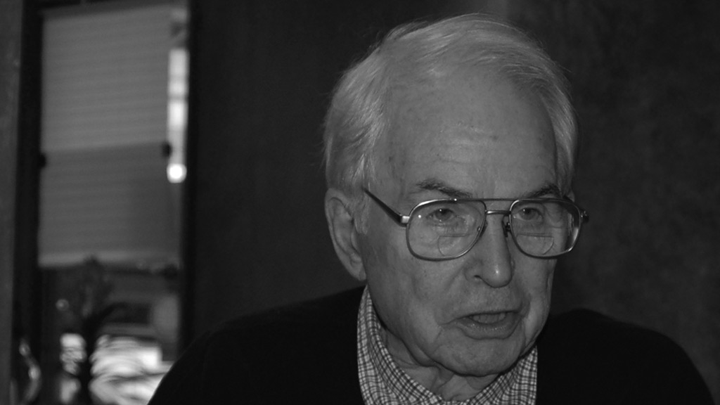 black and white photo of an elderly man wearing glasses 